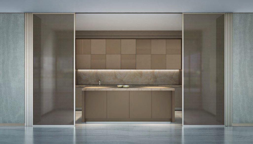 Kitchen with stone island and bronze cabinets behind sliding glass screens