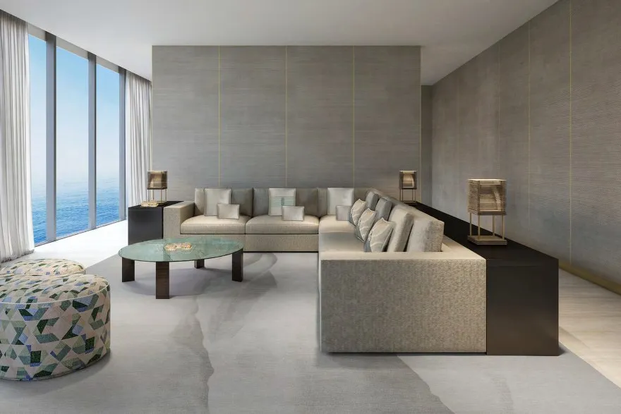 Living room with corner sofa, silk-panelled walls and tall sea-view windows
