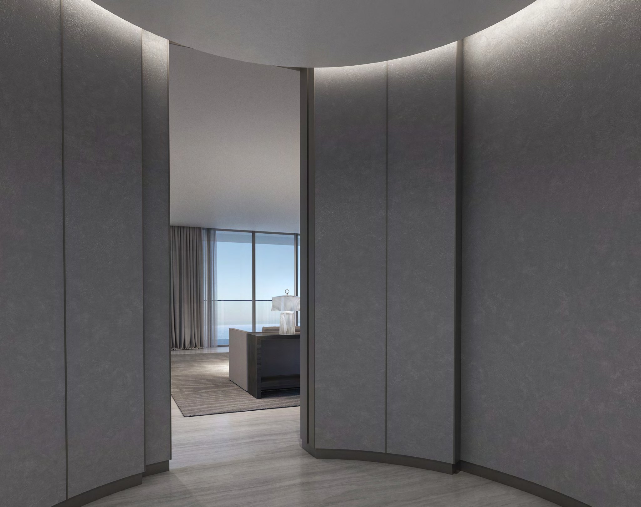 Curved panelled foyer opening onto a living room with sea views