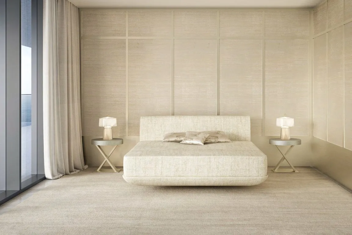 Cream bedroom with low bed and a glass wall onto the terrace and sea